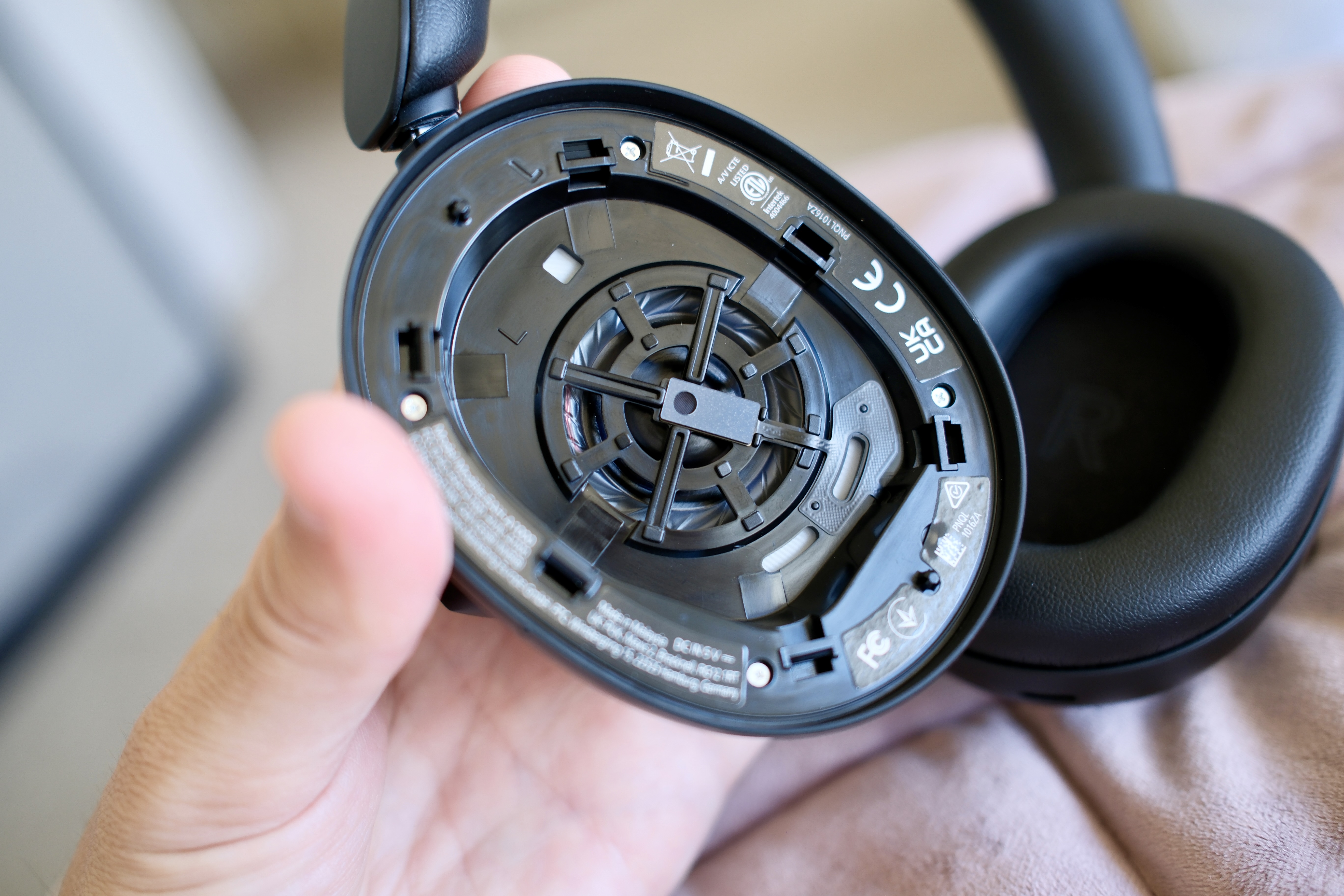 Holding a1000 headphones with the ear cushion off