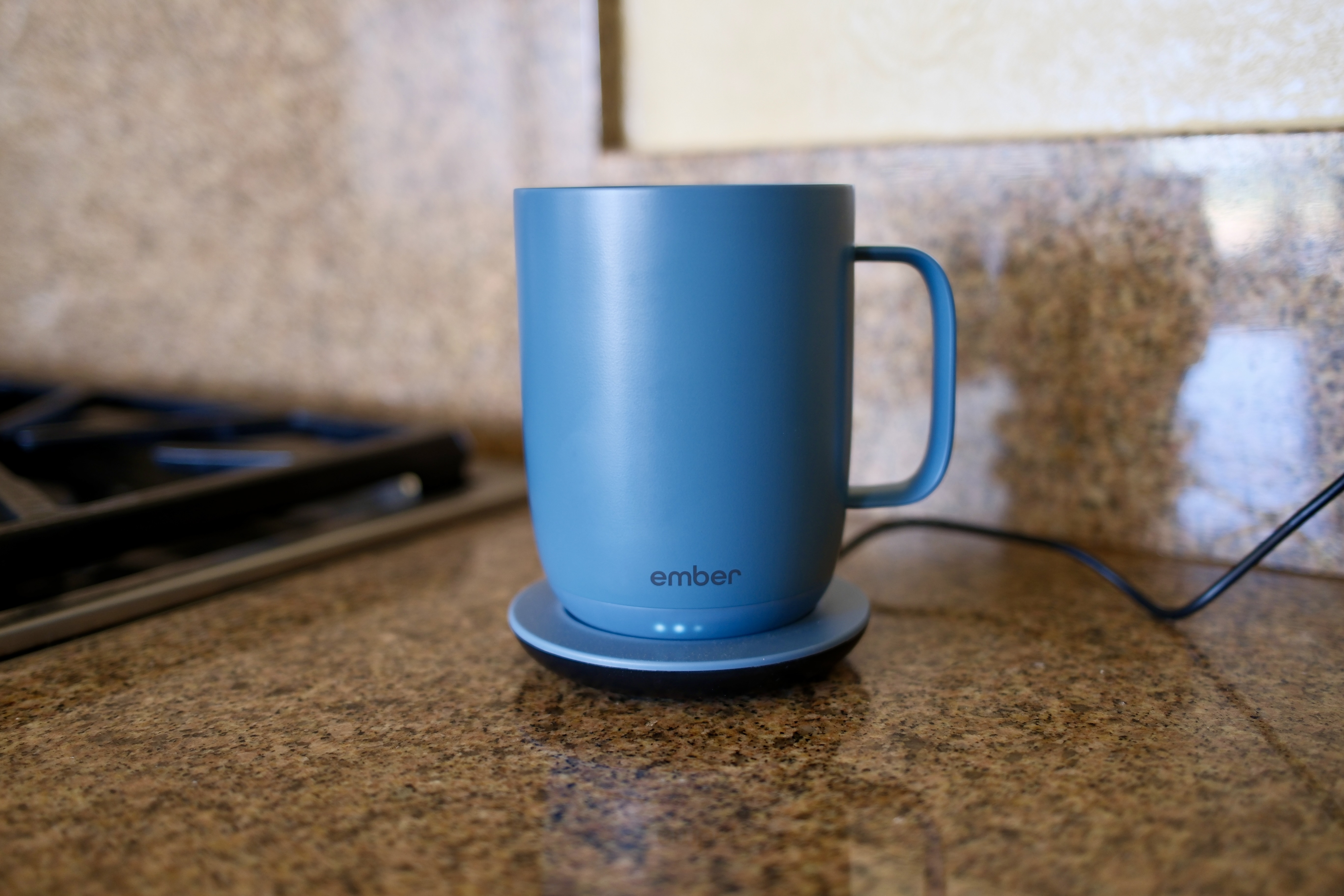 Ember Mug 3 sitting on its charging coaster