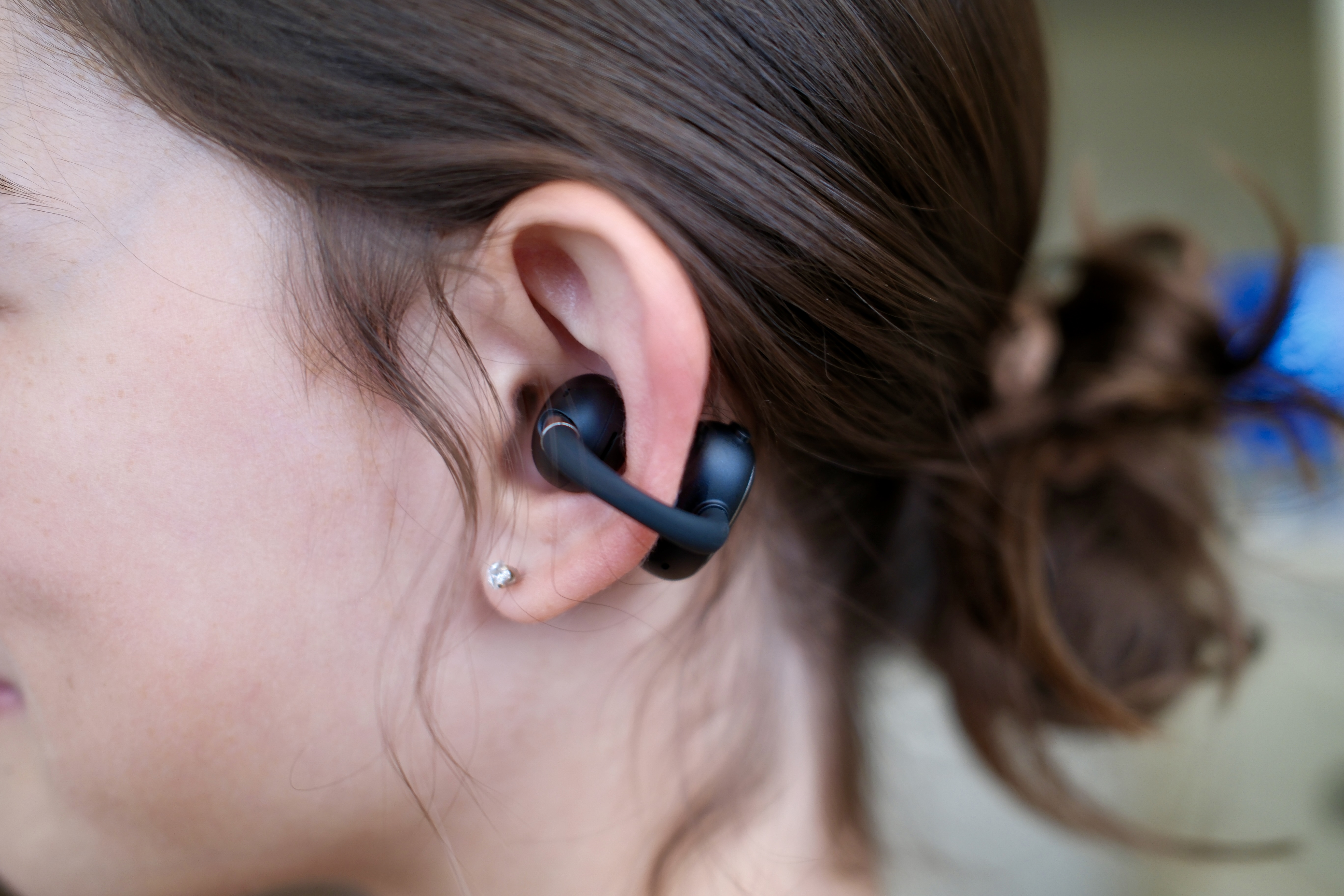 close up of someone's ear with the EarFun Clip 2 clipped on to the side