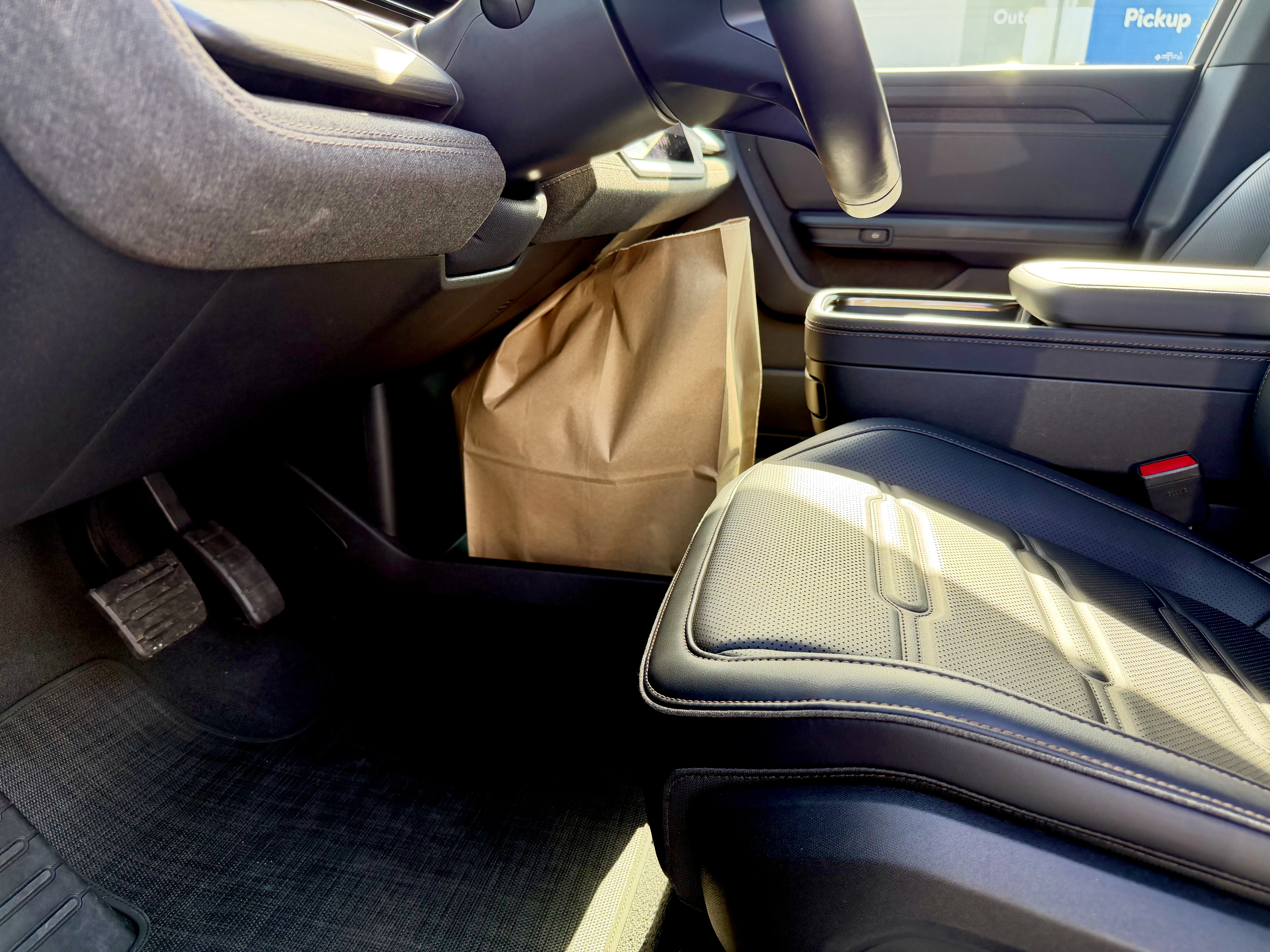 View of the R2 interior, showing a grocery bag in the middle front console