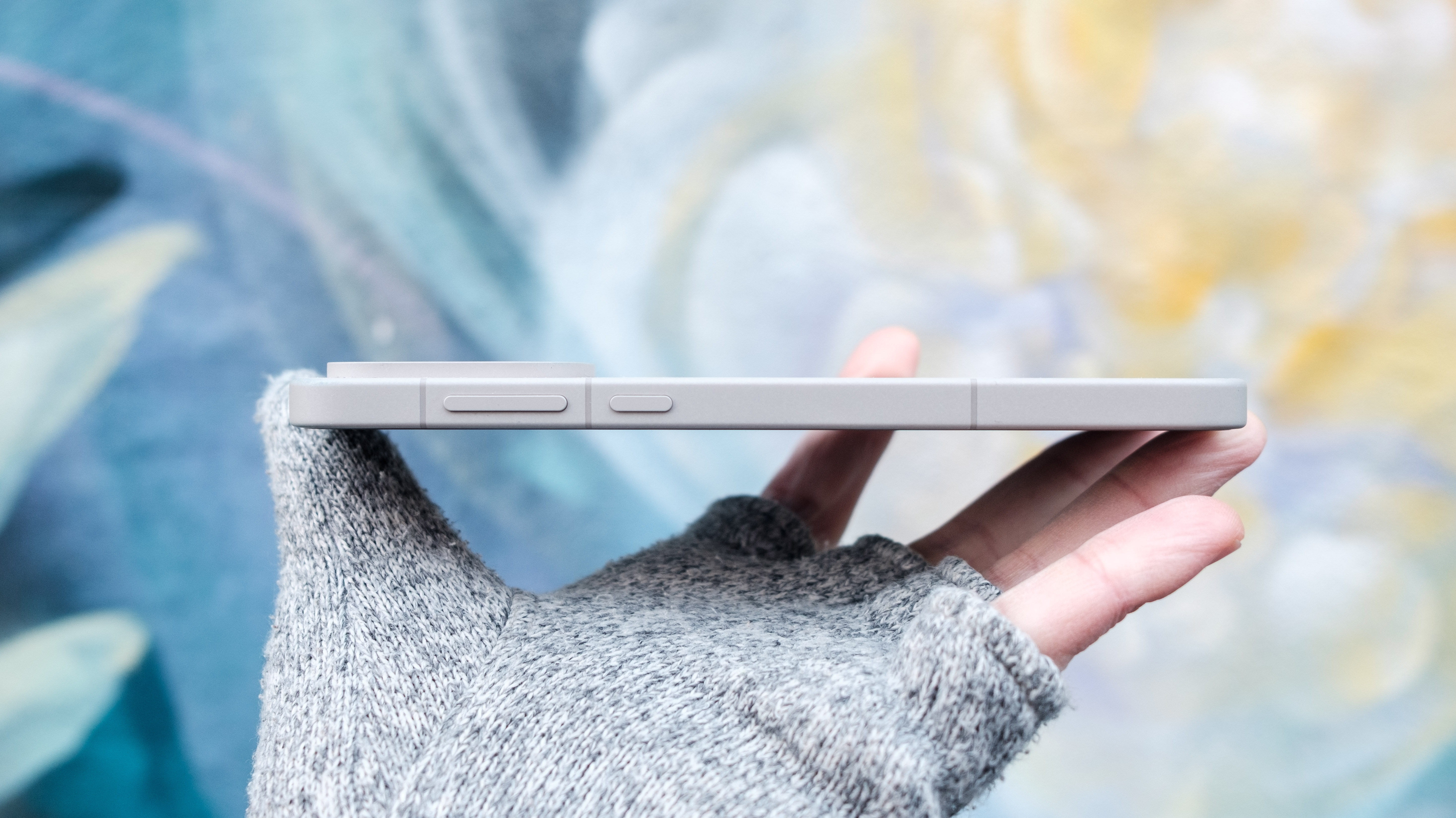 The OnePlus 15's volume rocker and power button are located on the right side of the phone.