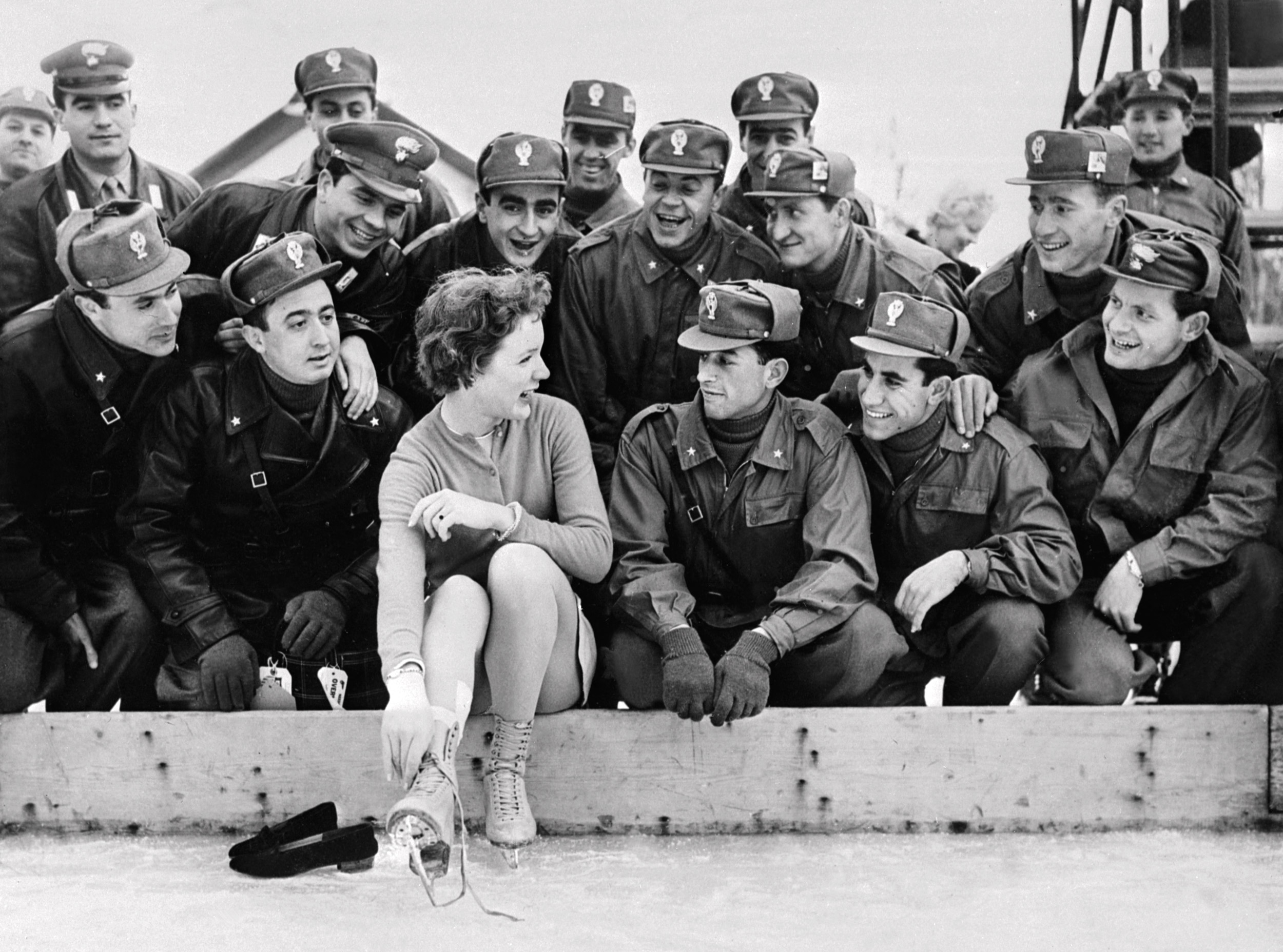 Albright poses with Italian soldiers on the edge of the Olympic ice rink. (Intercontinentale/AFP via Getty Images)
