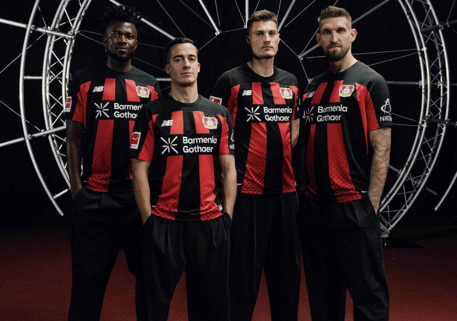 It's back to the black-and-red stripes for Bayer Leverkusen's 2026/27 home kits. The Bundesliga side have also incorporated a cross patern into the hem, "a reminder that Bayer 04 is more than just a club."
