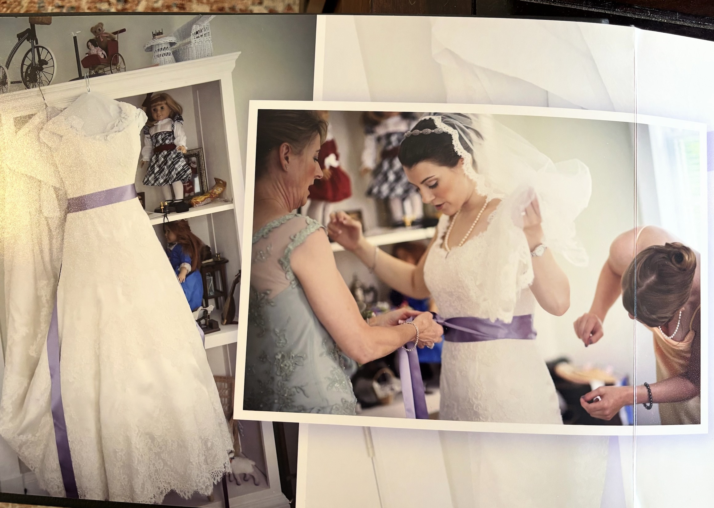 A bride getting dressed with American Girl dolls in the background.