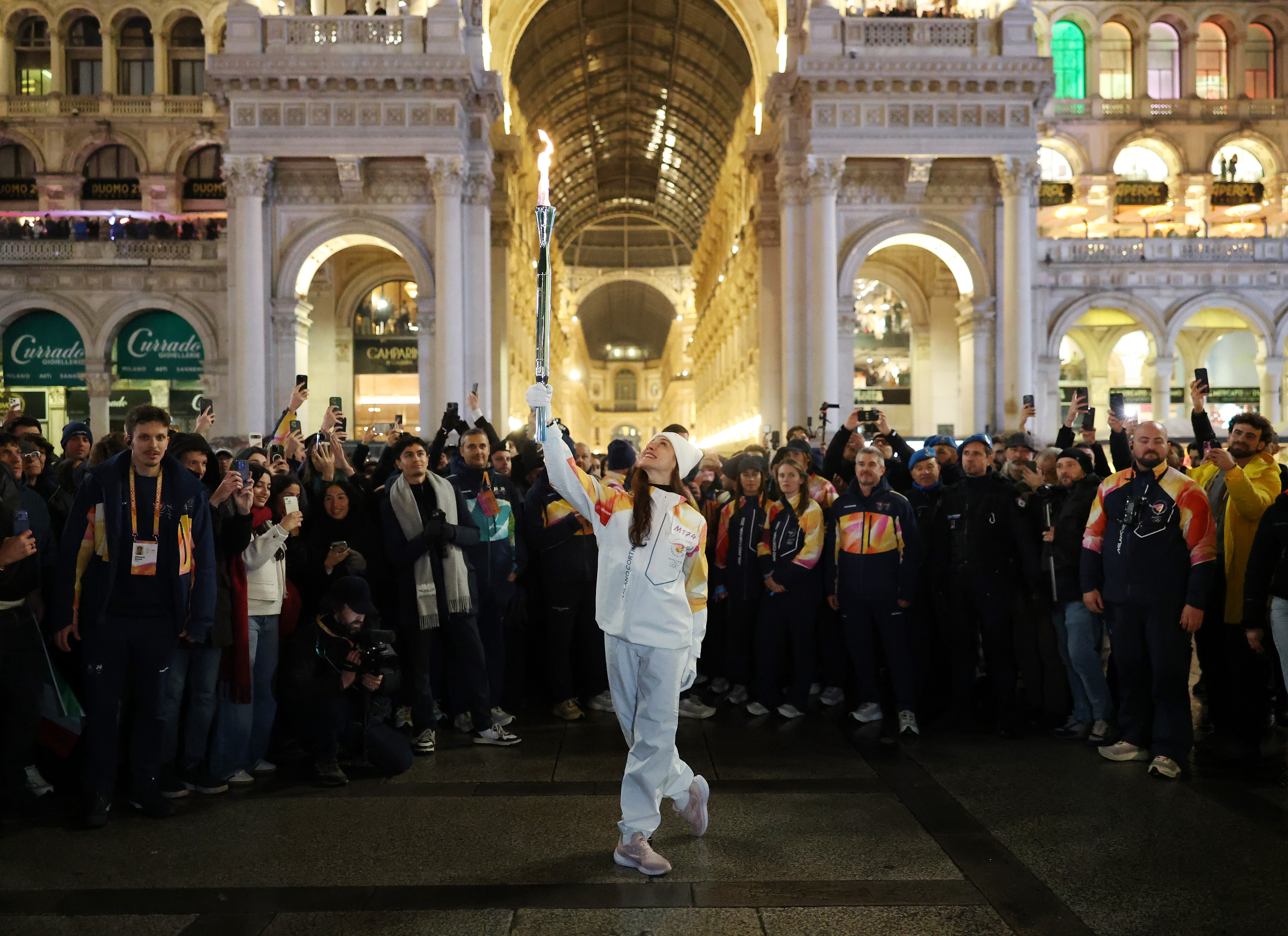 Italian ballet dancer Nicoletta Manni holds the Olympic flame on Thursday in front of Milan's Galleria Vittorio Emanuele II. (Andreas Rentz/Getty Images)